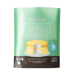 A green and brown package of CUP4CUP GLUTEN FREE YELLOW CAKE MIX by CUP4CUP, labeled "Gluten Free," features an illustration of a yellow layer cake with white frosting and a slice cut out. Perfect for premium baking.