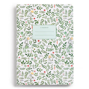The E. FRANCES PAPER STITCHED NOTEBOOKS GARDENER, SET OF 2, featuring a green and white checkered cover, is open on a white surface next to two striped pencils—one green and one pink—with the right page blank.