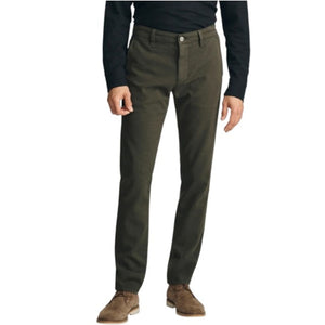 A person stands with their back to the camera against a neutral background, wearing the 34 HERITAGE - VERONA Straight Leg Chino Pant in Jasper High Flyer paired with a black long-sleeve shirt and brown suede shoes.