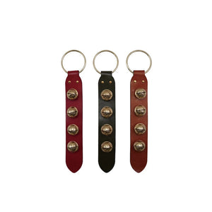 The LEATHER AND BELL DOOR HANGER by CREATIVE COOP comes in red, black, and brown leather with gold keyrings and studs—offering a classic door hanger look for a stylish way to accent your keys or bag.