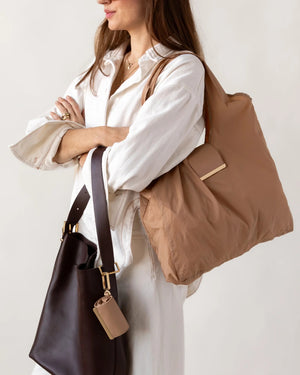KEOTE - KEYCHAIN TOTE IN CARAMEL by KEOTE, a compact caramel tote with an attached small rectangular pouch on the handle, shown on a white background. A matching keychain tote pouch is placed above the stylish reusable bag.