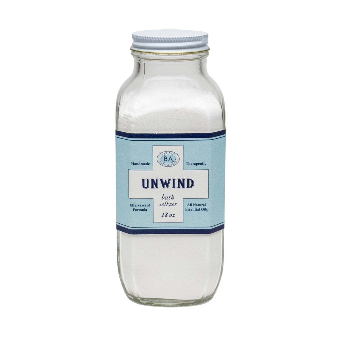 A clear glass bottle labeled &quot;BAUDELAIRE - UNWIND BATH SELTZER 18 OZ&quot; contains bath detox powder. The blue label, accented in white and darker blue, indicates the product is handmade and therapeutic. It features an effervescent formula with all-natural essential oils designed for luxurious bath soaks under the BAUDELAIRE brand.