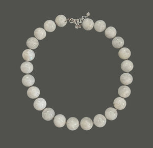 The ANN LIGHTFOOT - WHITE MOONSTONE RAS DU COU NECKLACE features smooth, large white moonstone beads and a sterling silver clasp, arranged in a circle on a white background.