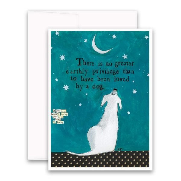 The CURLY GIRL DESIGNS - LOVED BY A DOG CARD from CURLY GIRL DESIGN, INC showcases an illustration of a person in a white dress hugging a dog beneath a starry night sky and crescent moon. The card features the text, "There is no greater earthly privilege than to have been loved by a dog," with smaller text that reads, “If you have been lucky, you'll soon be lucky again.”