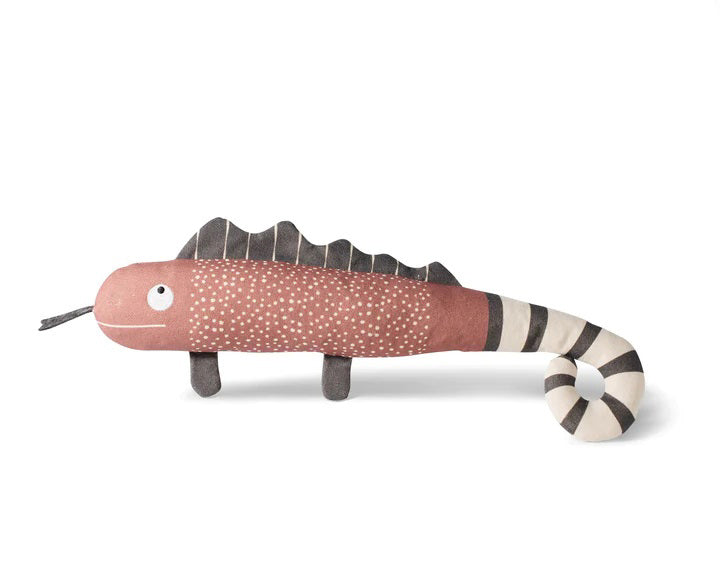 The FRINGE STUDIO - ONE IN A CHAMELEON CANVAS DOG TOY by PET SHOP BY FRINGE STUDIO is a plush toy designed to resemble a chameleon with a pink body, white speckles, and dark brown fins on its back. It features a black and white striped tail, stubby legs, and a smiling face with googly eyes. Made with non-toxic ink for safe play, this interactive dog toy is set against a plain white background.