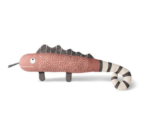 The FRINGE STUDIO - ONE IN A CHAMELEON CANVAS DOG TOY by PET SHOP BY FRINGE STUDIO is a plush toy designed to resemble a chameleon with a pink body, white speckles, and dark brown fins on its back. It features a black and white striped tail, stubby legs, and a smiling face with googly eyes. Made with non-toxic ink for safe play, this interactive dog toy is set against a plain white background.