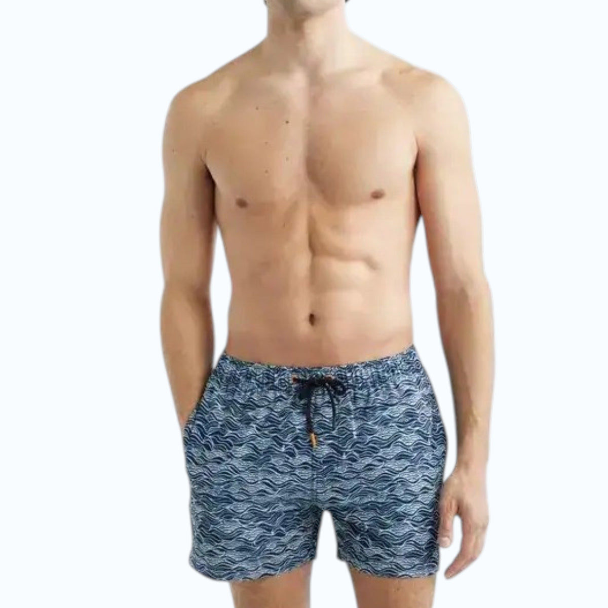 A shirtless man stands with hands in his pockets against a plain light background, modeling SAVE THE DUCK's Ademir Swim Trunks in Ondine Off White on Blue, crafted from quick-dry recycled polyester.