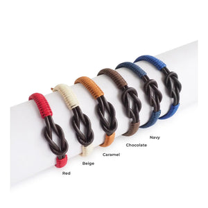 The MAKARLA Men's Infinity Knot Leather Bracelet in chocolate features a handmade design with genuine leather and an adjustable sliding knot, displayed on a white cylindrical stand and labeled by color.