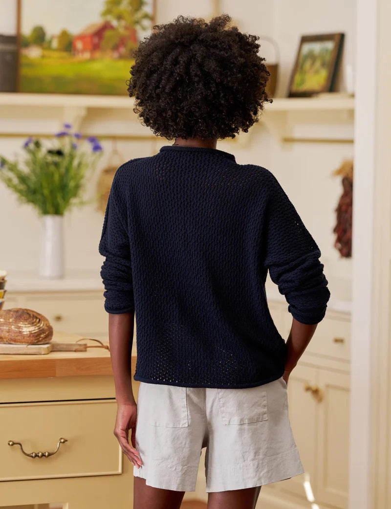 The FRANK &amp; EILEEN MONTEREY Pointelle Rolled Funnel Neck Sweater in Marine features a loose, textured Italian pointelle knit, long sleeves, high rolled neckline, and is crafted from 100% cotton. Shown laid flat on a white background.