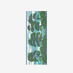 The INOUI EDITIONS - AMBROISE SCARF IN GREEN by INOUI features an illustrated design of green trees and blue sky on a plain white background, evoking a scenic outdoor view reminiscent of nature.