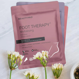 The BEAUTY PRO BEAUTYPRO - FOOT THERAPY BOOTIE comes in pink packaging and provides a 20-minute, vegan treatment with a removable toe tip. Scented with sweet almond, peppermint, and honeysuckle, this anti-ageing formula is moisturizing and suitable for use with nail polish.