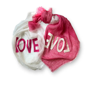 Discover the CITRUS FASHIONS OMBRE LINEN LOVE SCARF, an elegant blend of colors and emotions with one half in vibrant orange and the other in pure white. This dip-dyed treasure spells "LOVE" in contrasting letters, adding warmth and charm to any outfit.