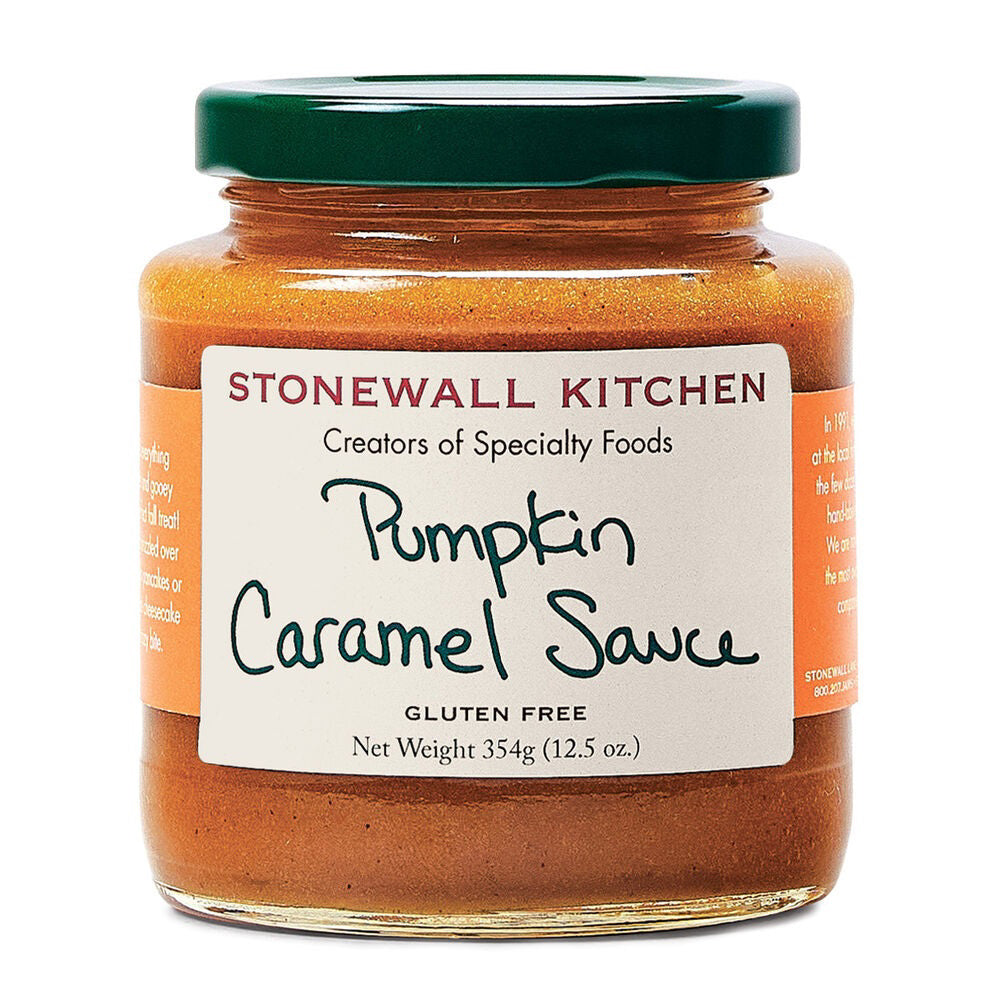 A 354g (12.5 oz) jar of STONEWALL KITCHEN Pumpkin Caramel Sauce, labeled as gluten-free, features a green lid and a label adorned with handwritten-style text spelling out the product&#39;s name. This light brown caramel sauce is an ideal fall treat for drizzling over homemade cheesecake.