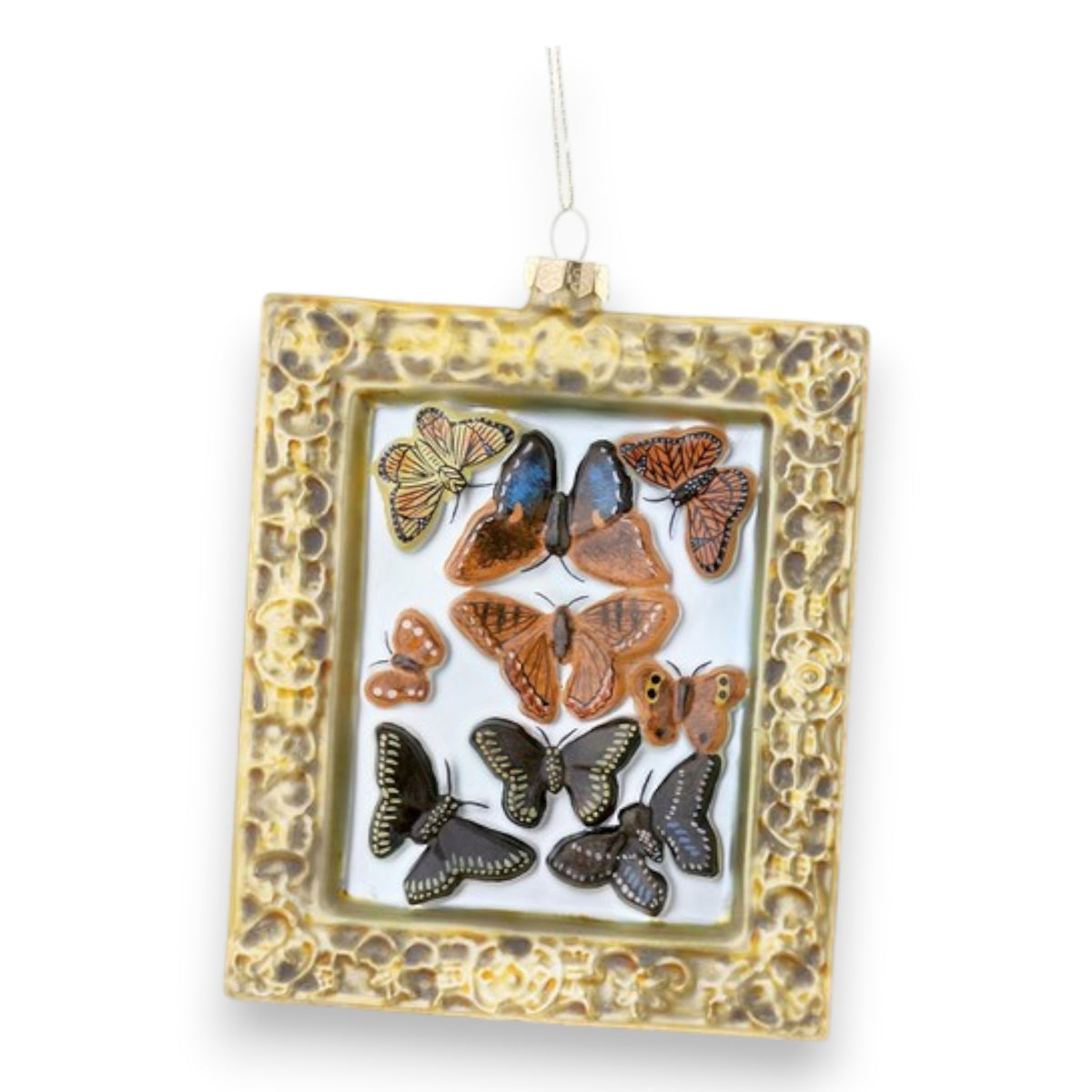 The CODY FOSTER VICTORIAN BUTTERFLY ORNAMENT is a golden frame ornament with vibrant butterflies inside and a hanging loop—an ideal gift or collectible for butterfly lovers.