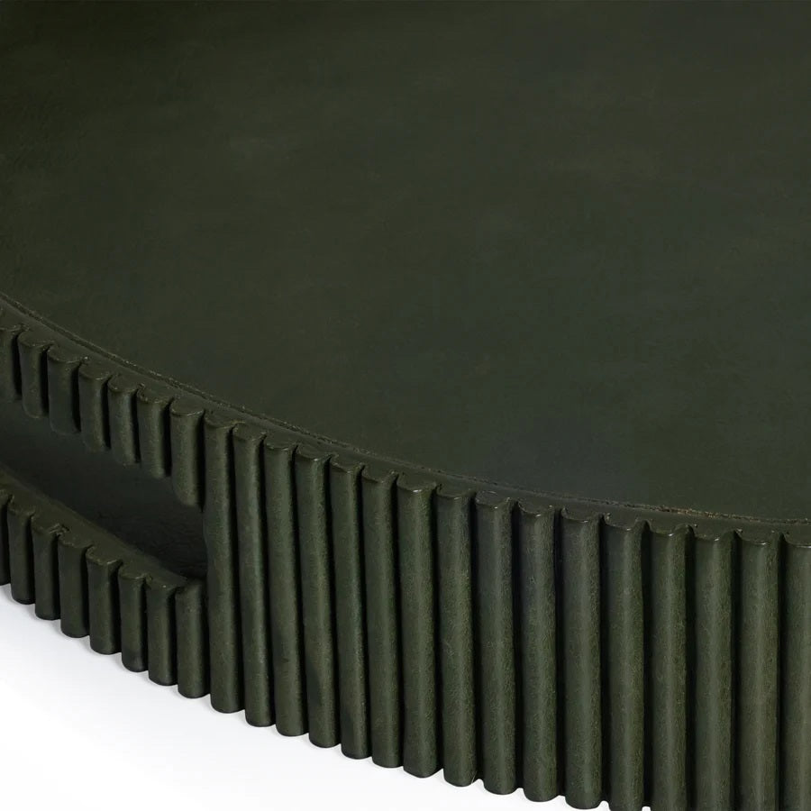 Close-up of the ZODAX ROUND FLUTED LEATHER TRAY IN GREEN, showcasing a smooth top and vertical, evenly spaced ridges on the sides for a modern, textured look.