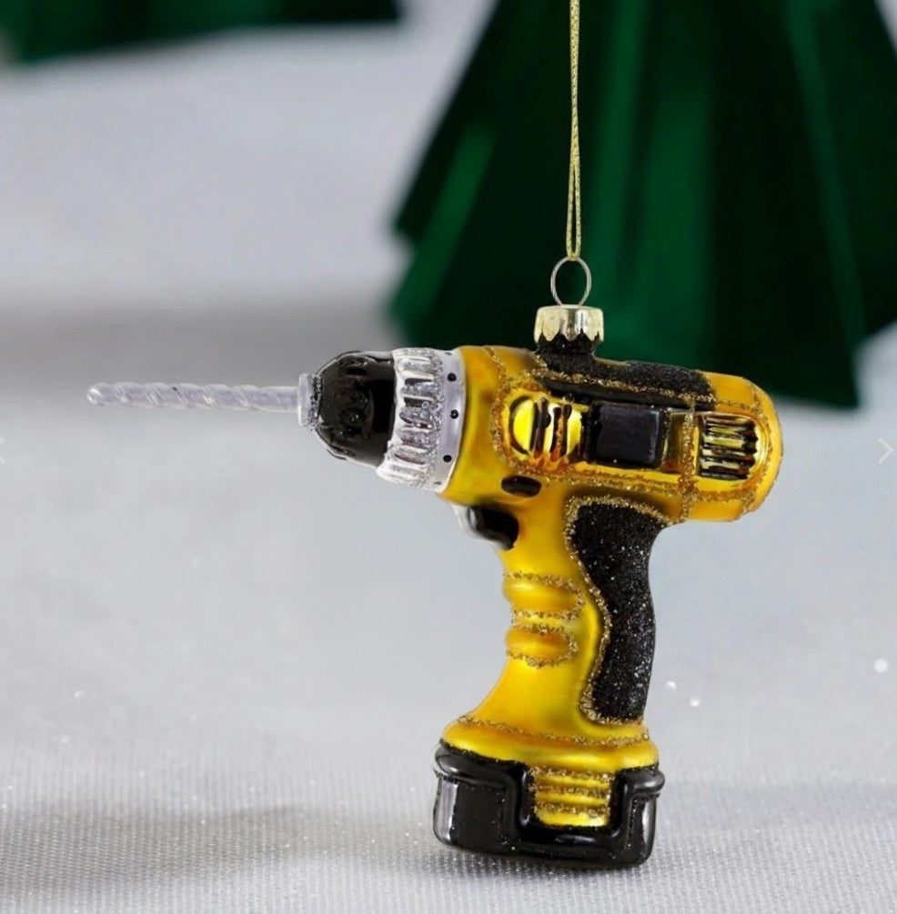 Cody Foster GLASS CORDLESS DRILL ORNAMENT, a 4.5-inch glass holiday ornament shaped like a yellow and black cordless power drill.