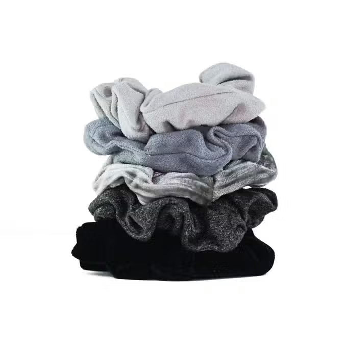 A set of five velvet hair scrunchies in stylish black and gray shades, displayed on a card labeled "KITSCH - VELVET SCRUNCHIES" by KITSCH.