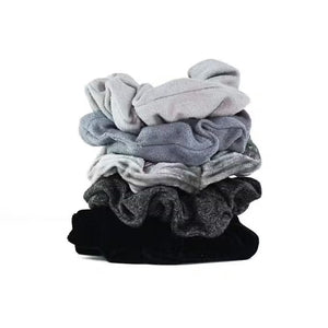 A set of five velvet hair scrunchies in stylish black and gray shades, displayed on a card labeled "KITSCH - VELVET SCRUNCHIES" by KITSCH.