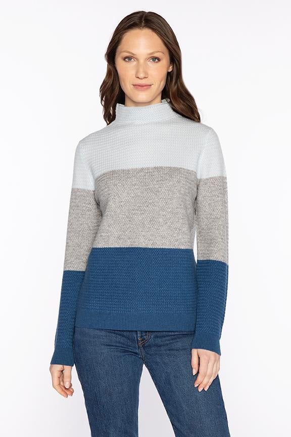 The KINROSS CASHMERE Textured Colorblock Funnel Neck Sweater by KINROSS features a luxurious knit, long sleeves, and a high neck in cream, gray, and light brown tones, shown on a white background.