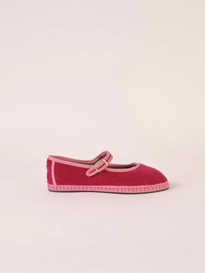 A single SVETI STEFAN - MARY JANE SHOE with a buckle strap, handmade in Spain, is displayed on a plain light background. The shoe features a dark pink body with lighter pink trim and a light pink sole, all crafted from cotton fabric.