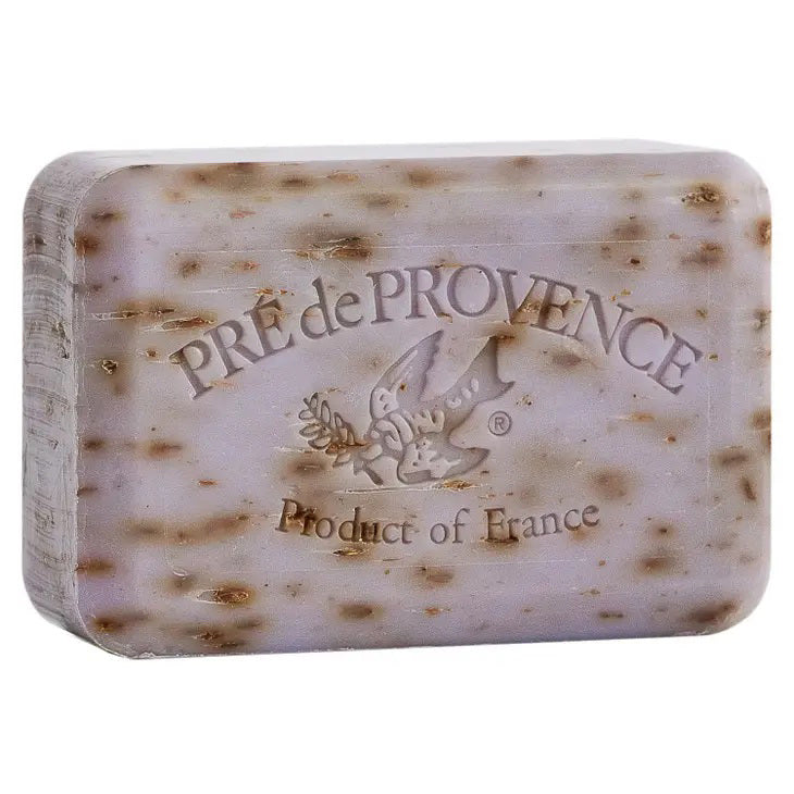 A rectangular bar of LAVENDER BAR SOAP 150G by EUROPEAN SOAPS, LLC with the text "PRE de PROVENCE Product of France" and an image of a bird holding an olive branch imprinted on its surface. This French-milled soap is light lavender with small brown speckles throughout.