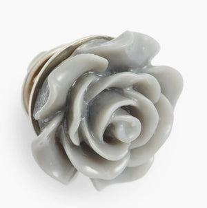 The CLIFTON WILSON RESIN LAPEL FLOWER PIN features vibrant orange and yellow petals in a rose-like design, closely resembling a wedding boutonniere, and is photographed against a plain white background.