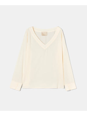 The MOMONI - TERENCE V NECK TOP by MOMONI is a long-sleeved, cream silk crepe blouse with a V-neckline and cuffed sleeves, shown laid flat on a white background.