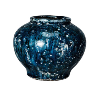 The CREATIVE COOP Decorative Terracotta Vase with Blue Crackle Glaze, Small, features a round, wide-mouthed design and glossy marbled blue-black finish with subtle white speckles, shown against a plain white background.