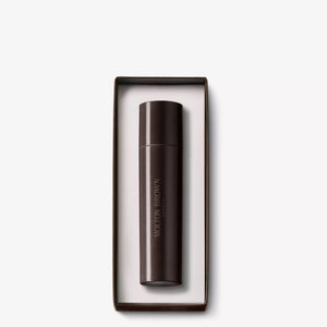 A dark brown cylindrical MOLTON BROWN 7.5ML Eau de Parfum bottle sits inside a matching rectangular MOLTON BROWN Travel Case with a white interior, both displayed against a plain white background.