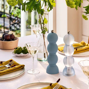 The ADDISON ROSS SCANDI BOBBIN SALT OR PEPPER MILL 23 CM features a modern stacked-sphere design in matte chambray acrylic with a metallic knob and a durable ceramic grinder, inspired by classic Scandinavian bobbin mills.