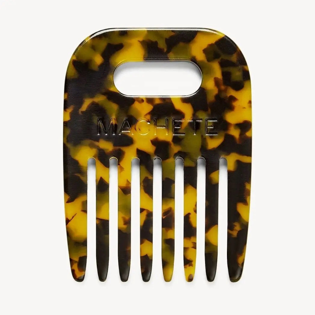 The MACHETE No. 4 Comb in Tortoise is a wide-tooth comb for curly hair, made from Italian acetate in a yellow-brown tortoiseshell pattern, with a rectangular handle cutout and "MACHETE" embossed on the front.