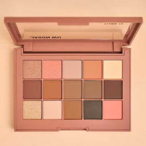 The JASON WU BEAUTY FLORA 15 EYESHADOW is a large, rectangular shadow palette that features 15 vibrant shades. It includes a variety of matte, shimmer, and metallic finishes in tones ranging from neutrals to bold colors like peach and pink. The name 'JASON WU' is printed inside the palette.
