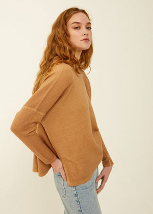 A close-up view of dark blue, textured fabric with a subtle pattern. The tightly woven fabric creates a smooth yet slightly fuzzy surface. Made in Italy by BASE MILANO, the color and texture suggest suitability for high-quality garments like the BOATNECK WOOL SWEATER, boxy fit jackets, or jeans.