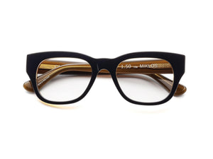 The CADDIS - MIKLOS PROGRESSIVE READERS by CADDIS are black, thick-rimmed rectangular eyeglasses with scratch-resistant lenses and beige inner arms, displayed against a white background.