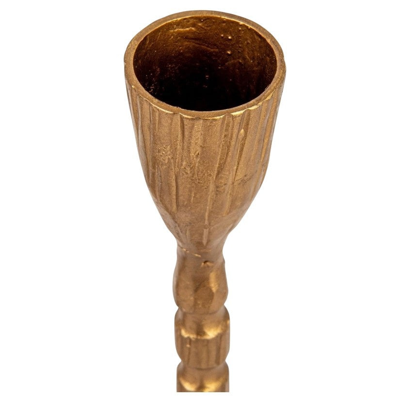 The CREATIVE COOP CAST IRON TAPER HOLDER IN BRASS FINISH, MEDIUM features a sleek, textured stem and round base, bringing elegant style to any setting.