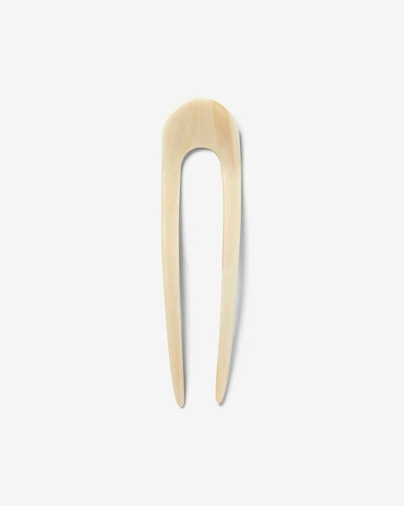 A smooth, black MACHETE - FRENCH HAIR PIN with two prongs, crafted from Italian acetate by MACHETE, rests on a plain white surface.