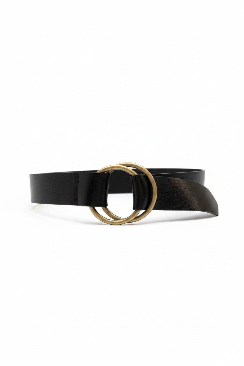 The ADA - JOSIE BELT by ADA is a brown leather belt featuring two overlapping brass rings as the buckle, displayed flat on a white background.