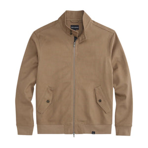 Close-up of a person wearing the MACK WELDON Twill Harrington Jacket in Shroom, featuring a zip front and buttoned flap pocket. Their arm is relaxed by their side and dark denim jeans are partially visible.