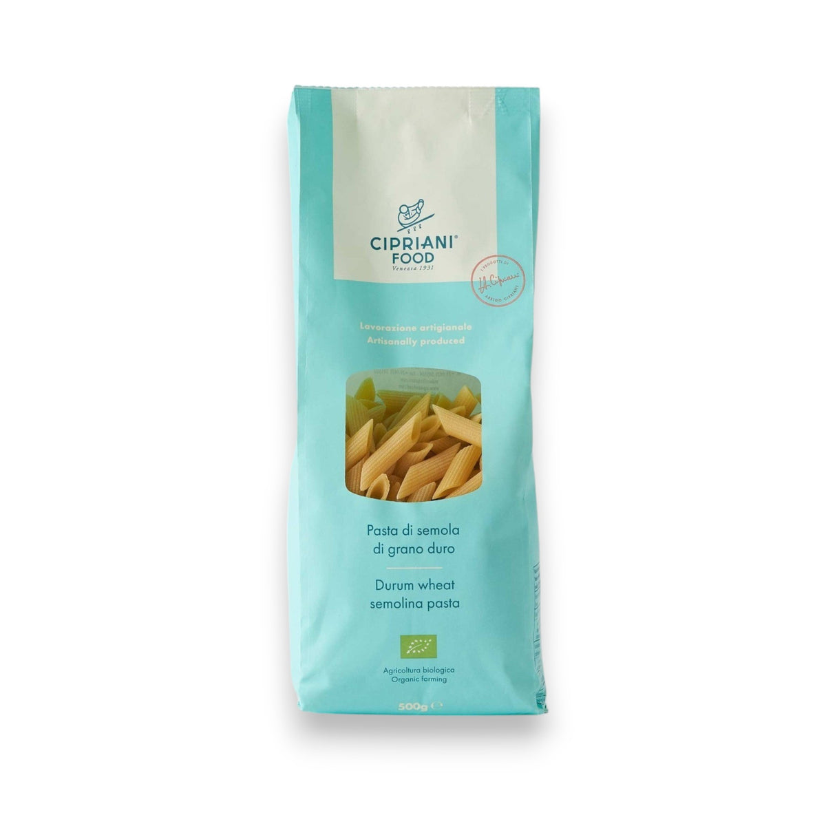A light blue package of ATALANTA CORPORATION's CIPRIANI - ORGANIC DURUM WHEAT PENNE PASTA stands against a plain white background. The bag features a transparent window displaying the high protein index pasta inside and text detailing its Italian organic semolina content.