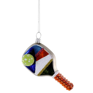 Cody Foster GLASS PICKLEBALL PADDLE ORNAMENT measuring 1.5 x 2.5 x 4 inches, featuring a colorful geometric design, a ribbed handle, and an attached ball.