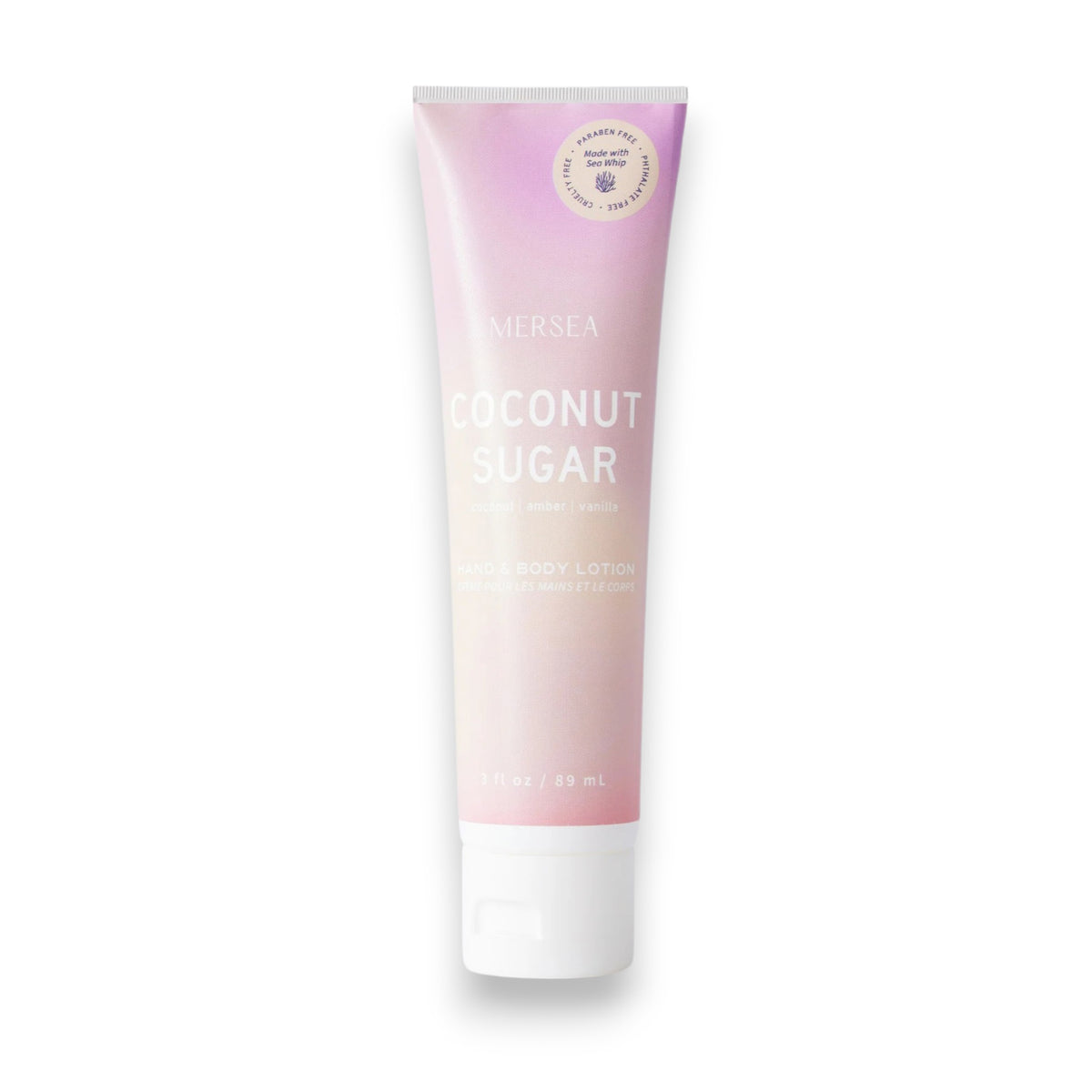 A tube of MERSEA - COCONUT SUGAR SEA WHIP LOTION, featuring a gradient pink and white design with gold and white text, enriched with Sea Whip Extract, and topped with a white flip-top cap.