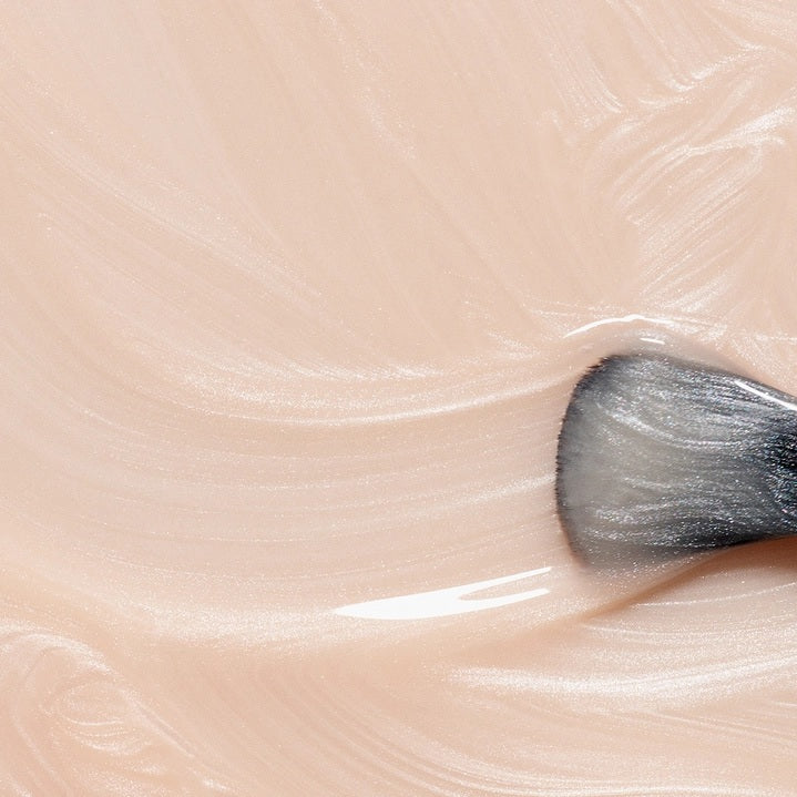A bottle of MANUCURIST INC’s GREEN™ Nail Polish in Pearlescent, featuring a quick-dry formula and intense color payoff. This vegan, non-toxic nail polish has a black cap and contains a shimmery off-white shade, delivering brilliant results without compromising on safety or performance.