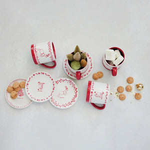 Creative Co-op stoneware mug with holiday design, red and white, featuring a white body with a red interior, base, and handle decorated with a red Christmas tree and string of lights pattern.