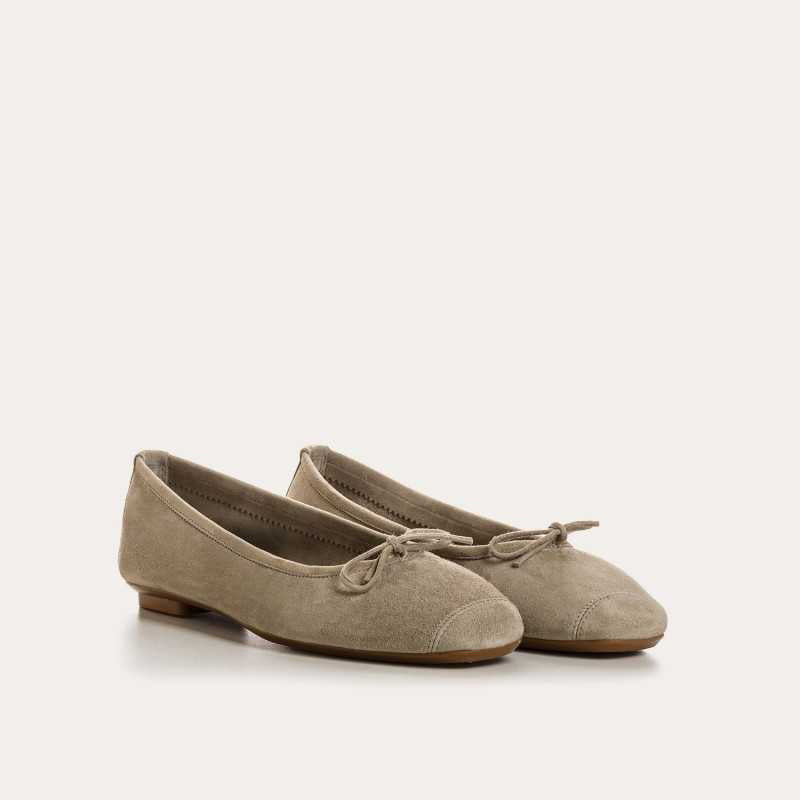The REQINS - HARMONY BALLERINA FLATS by REQINS are shown in taupe suede with a small front bow and low heel, displayed in side profile against a plain light background.