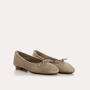 The REQINS - HARMONY BALLERINA FLATS by REQINS are shown in taupe suede with a small front bow and low heel, displayed in side profile against a plain light background.