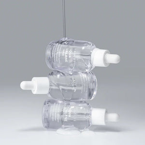 Three clear AQUA SQUALANE SERUM 50ML dropper bottles from ASIAN BEAUTY WHOLESALE are stacked with liquid dripping over them, set against a light gray background, showcasing this lightweight serum that helps tighten pores.