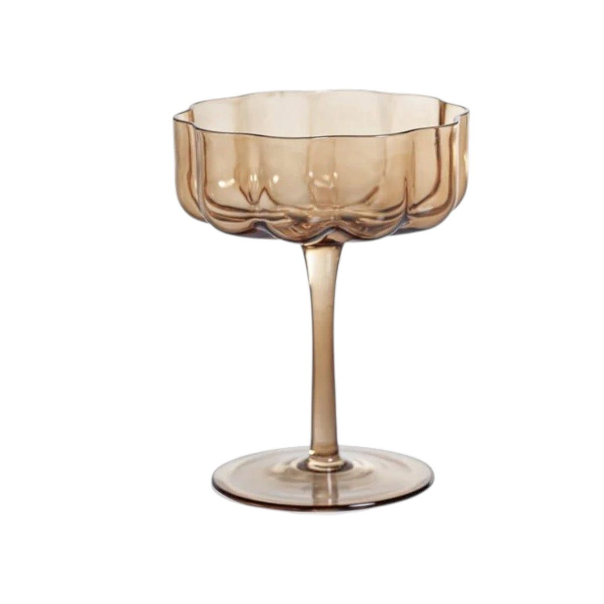 The ROCCO HANDBLOWN COUPE - AMBER by ZODAX features a brown-tinted, handblown amber glass with a scalloped, fluted bowl and a long stem, standing on a round base against a white background.