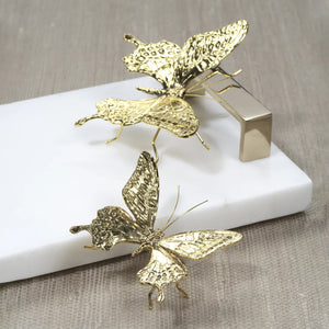 The ZODAX DECORATIVE ANTIQUE GOLD BUTTERFLY - LARGE is a gold metallic butterfly sculpture made from zinc alloy with detailed textured wings and thin legs, measuring 4.25" x 3.75" x 1.5", shown against a white background.