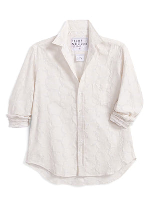 Introducing the FRANK & EILEEN - EILEEN Relaxed Button Up in Italian Cotton Textured Natural Flowers: a long-sleeve, button-up white shirt with a subtle floral texture, rolled cuffs, and a pointed collar. Designed for a relaxed fit, this shirt is crafted from premium Italian cotton and features thoughtfully placed buttons to flatter the bust for an effortlessly stylish silhouette. The signature label inside reads “FRANK & EILEEN EST 1947.”.