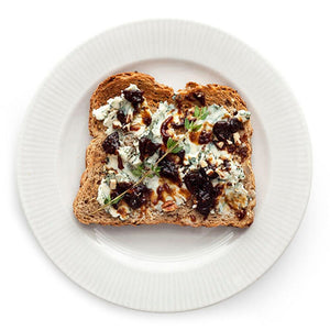 A glass jar of STONEWALL KITCHEN - FIG AND GINGER JAM, featuring a green lid and a white label with product details—ideal for spreading on breakfast breads or infusing marinades and glazes with a sweet-savory flavor.